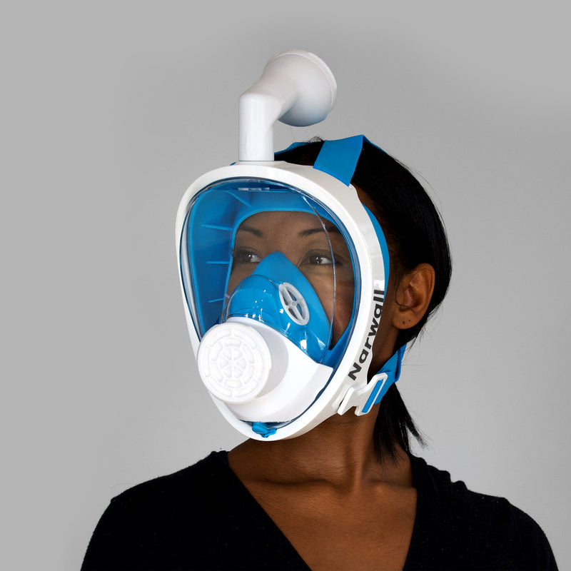 a woman models the Narwall Mask in blue, wearing a black shirt in front of a grey background.
